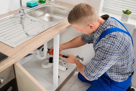 Plumber Fixing Kitchen — Atlanta, GA — Akins Plumbing
