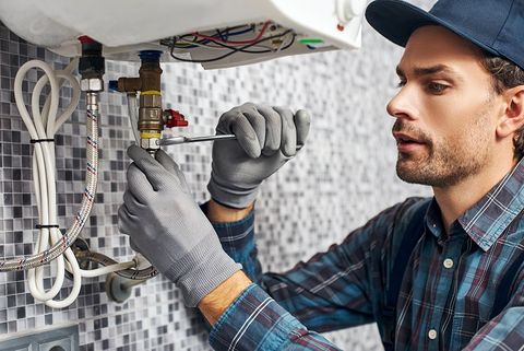 Worker Set Up Electric Heating Boiler — Atlanta, GA — Akins Plumbing
