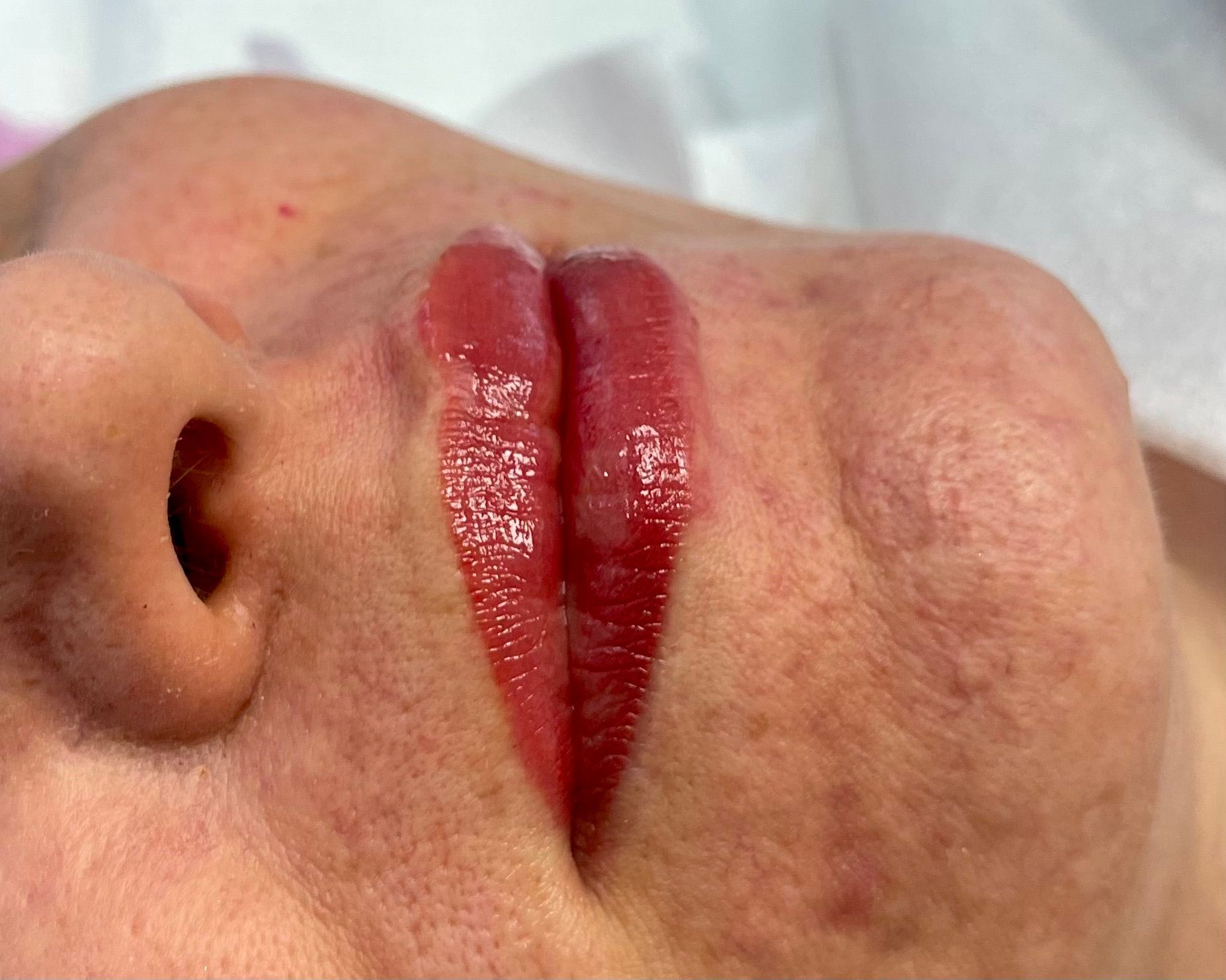 A close up of a woman 's face with red lips.