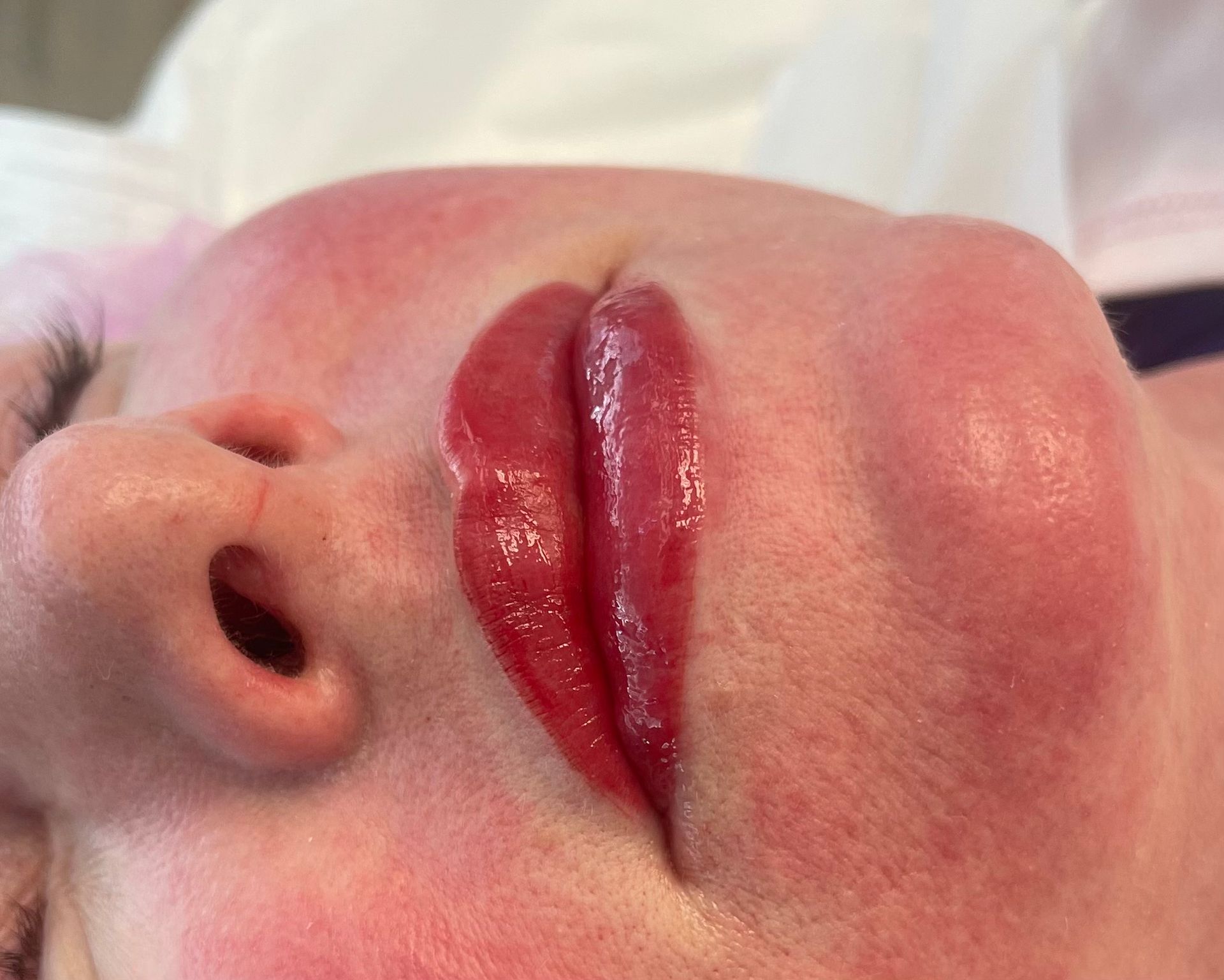 A close up of a woman 's face with red lips.